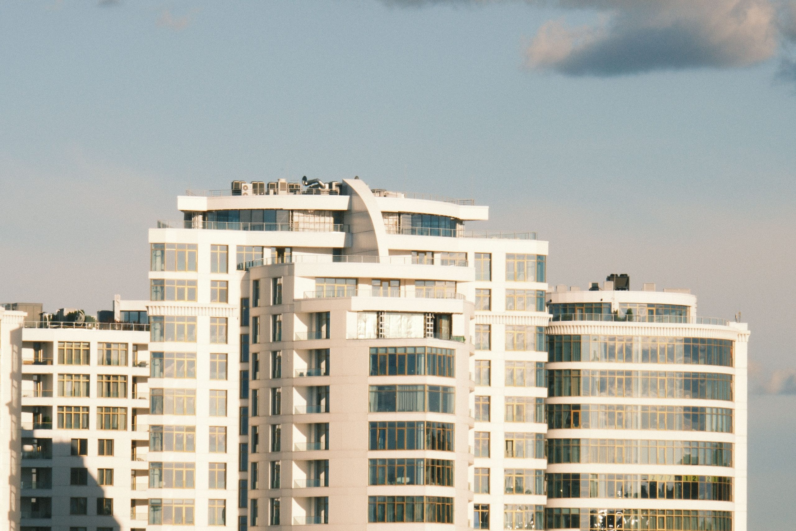 Contemporary high-rise buildings with a clear blue sky backdrop, capturing urban architecture.